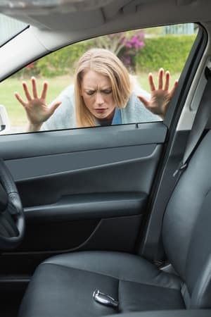 a woman is sad because her keys got locked in her car and she needs a denver car locksmith